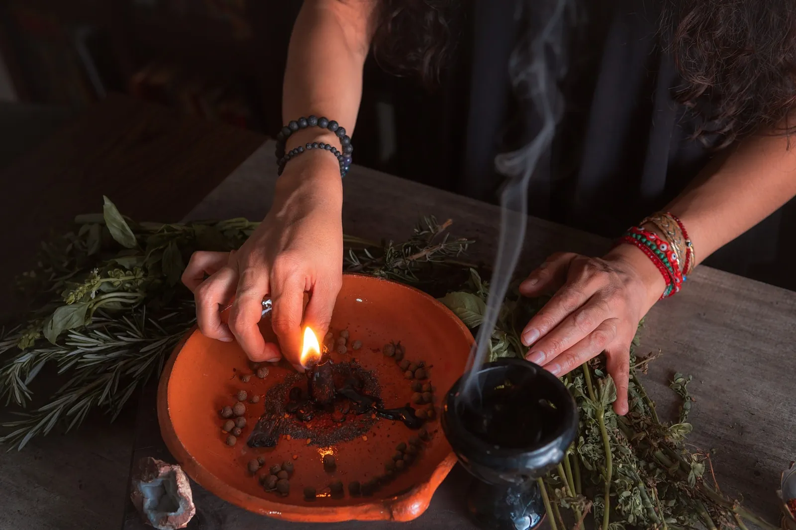 Herbs being lit in a ceremonial bowl