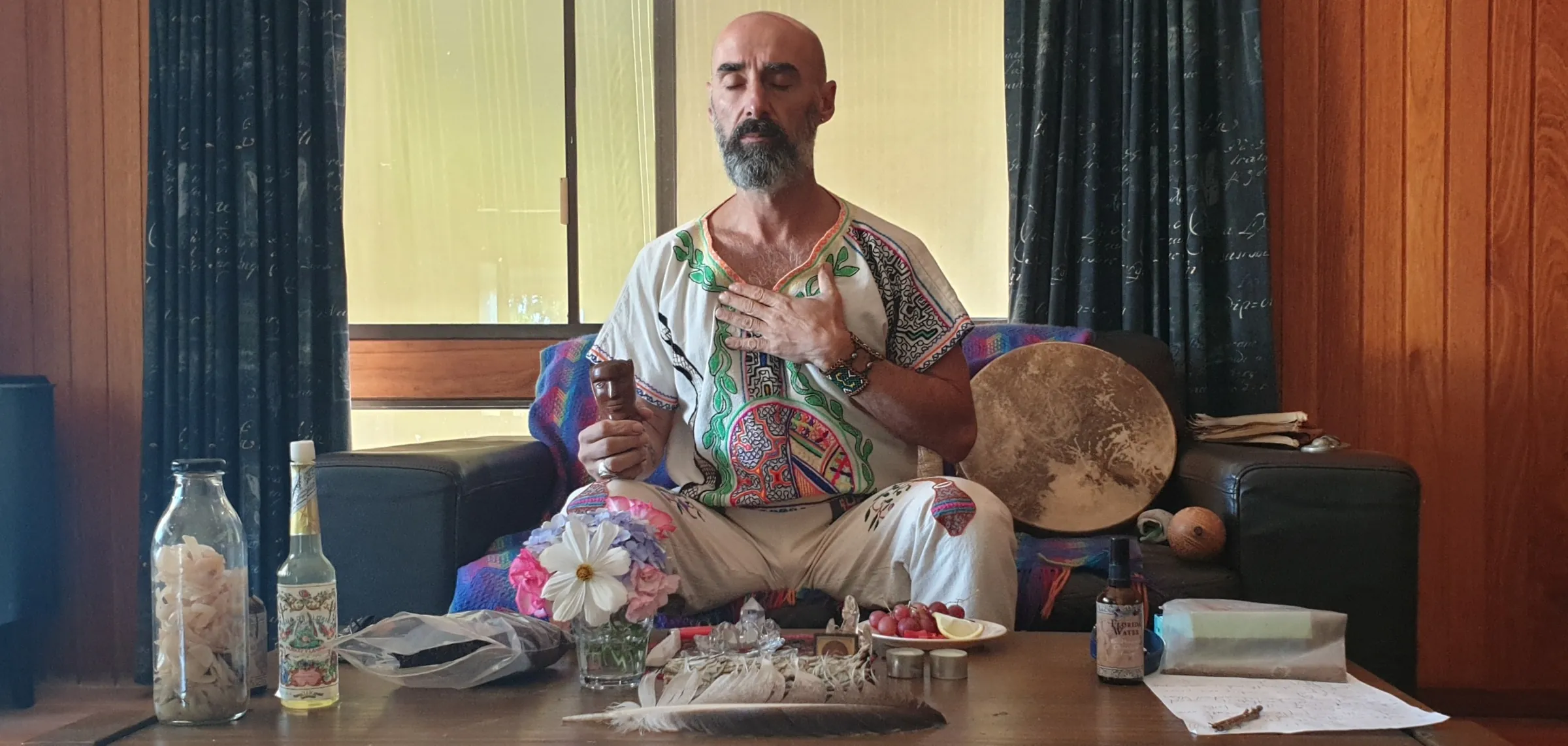 Loukas Panether seated with his drum and medicines